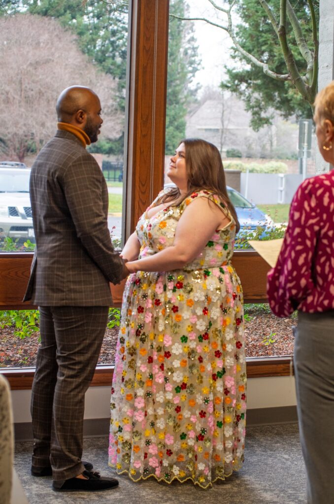 Wayne and Presleigh hold hands while making their vows during their wedding ceremony.